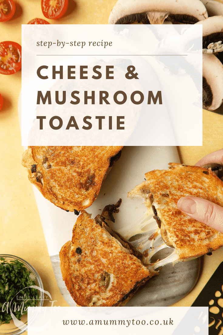 Two Jarlsberg cheese and mushroom toasties are on a serving board, one is being pulled apart very wide, the cheese is stretching between them almost to the point of breaking.