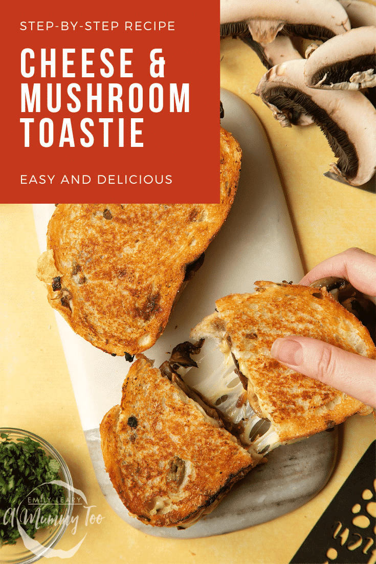 Two Jarlsberg cheese and mushroom toasties are on a serving board, one is being pulled apart so the cheese stretches out between them.