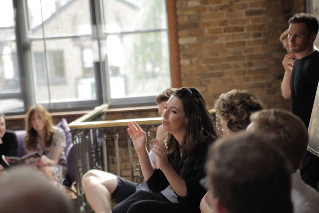 Emily Leary speaking at an event surrounded by fellow guests.