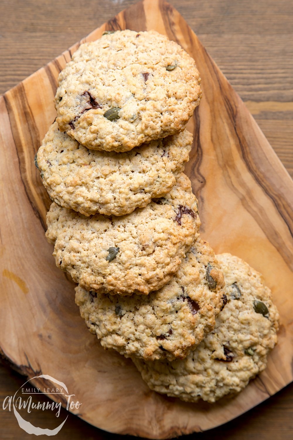 Vegan oat cookies arranged on a wooden board.