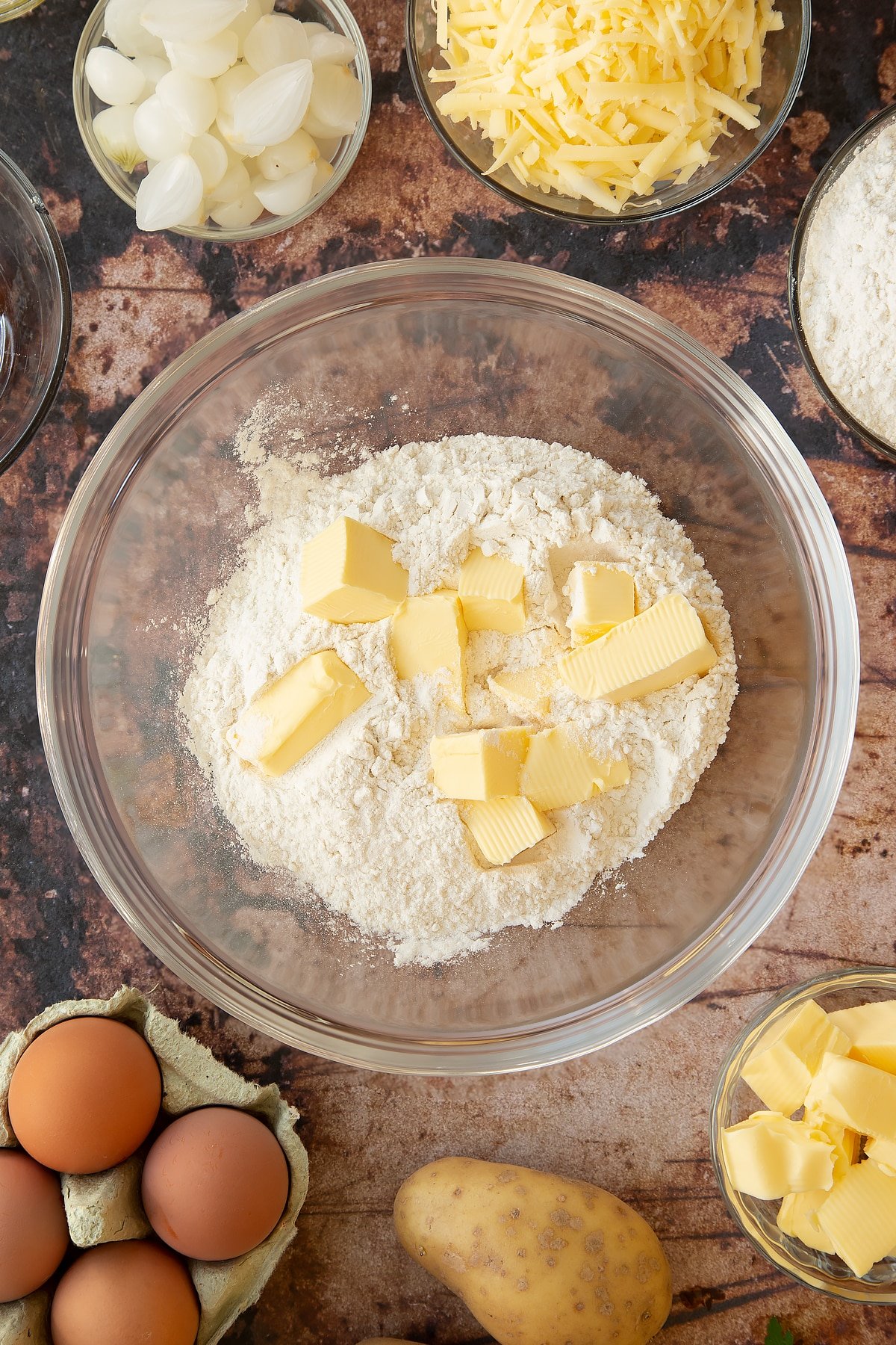 Overhead shot of butter and flour in a mixing bowl.