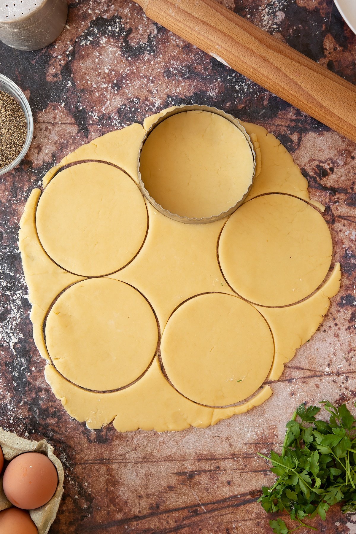 Rolled out pastry with a pastry cutter on the top.