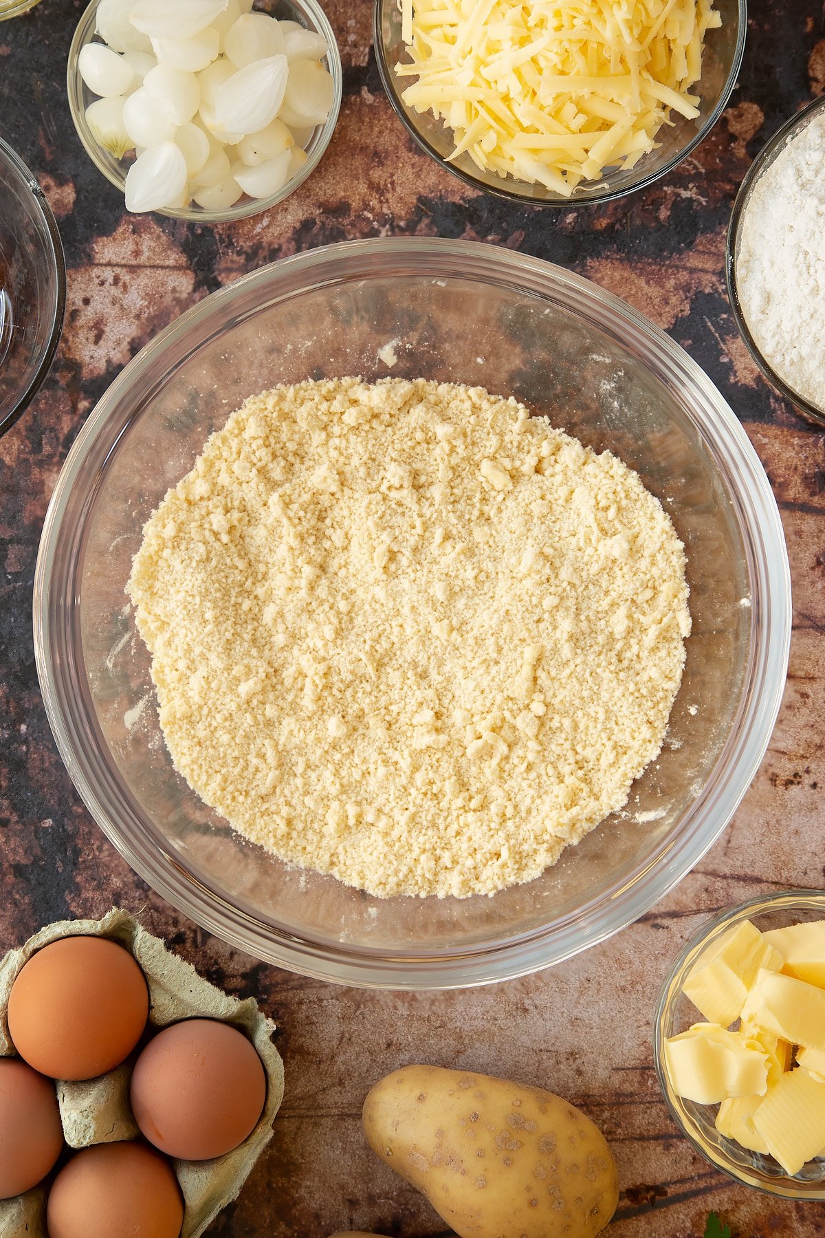 Overhead shot of the mixed dry ingredients for the recipe in a clear mixing bowl.