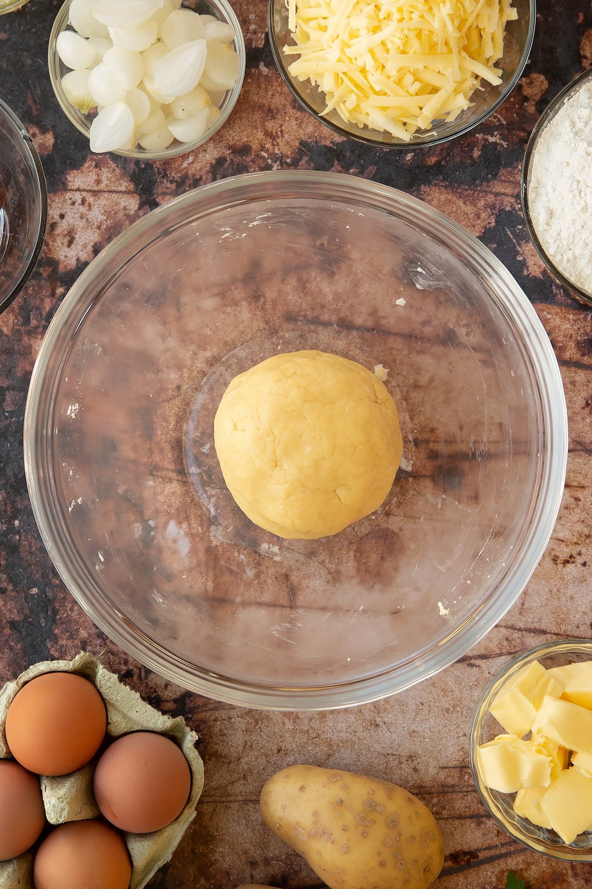 Overhead shot of the pastry ball in a clear mixing bowl.