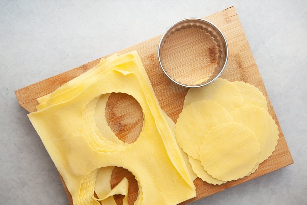 Cutting the lasagne layers with a pastry cutter