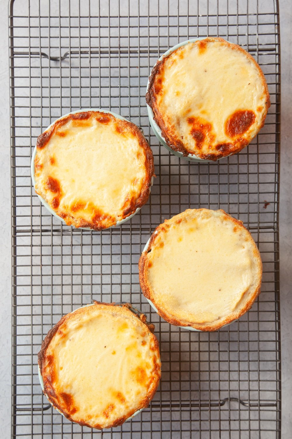 Baked lasagne pies, cooling on a wire rack