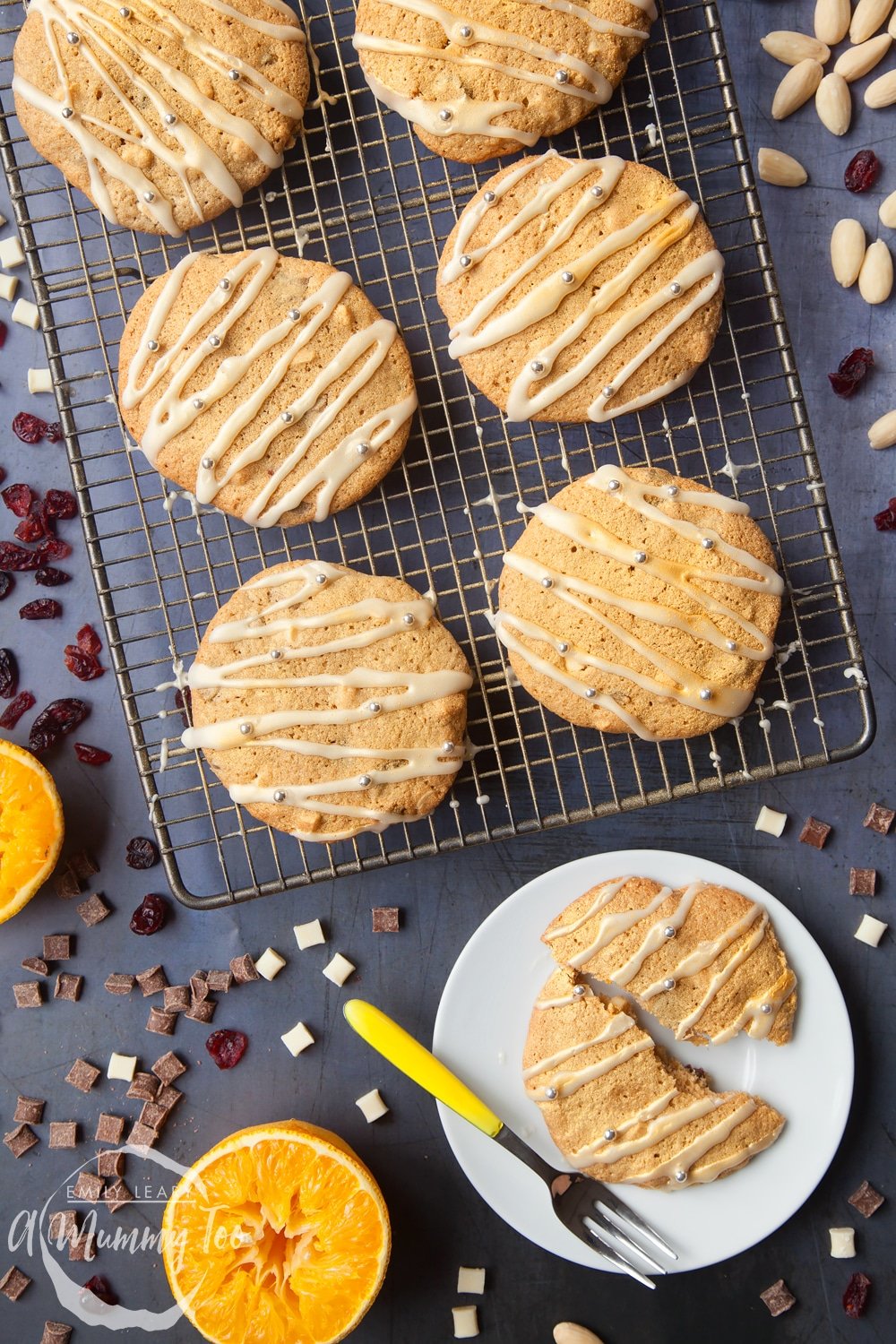 Overhead shot of Cranberry orange white chocolate cookies on a baking rack with a mummy too logo in the lower-left corner