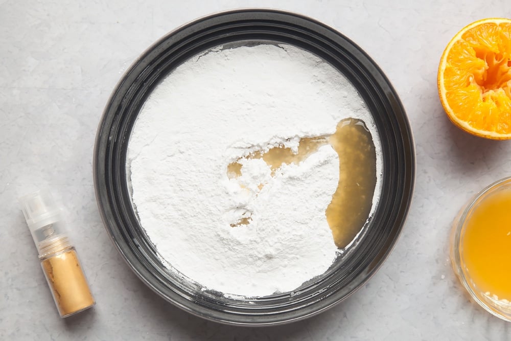 Overhead shot of sugar and margarine in a mixing bowl 