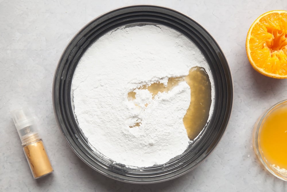 Overhead shot of sugar and margarine in a mixing bowl
