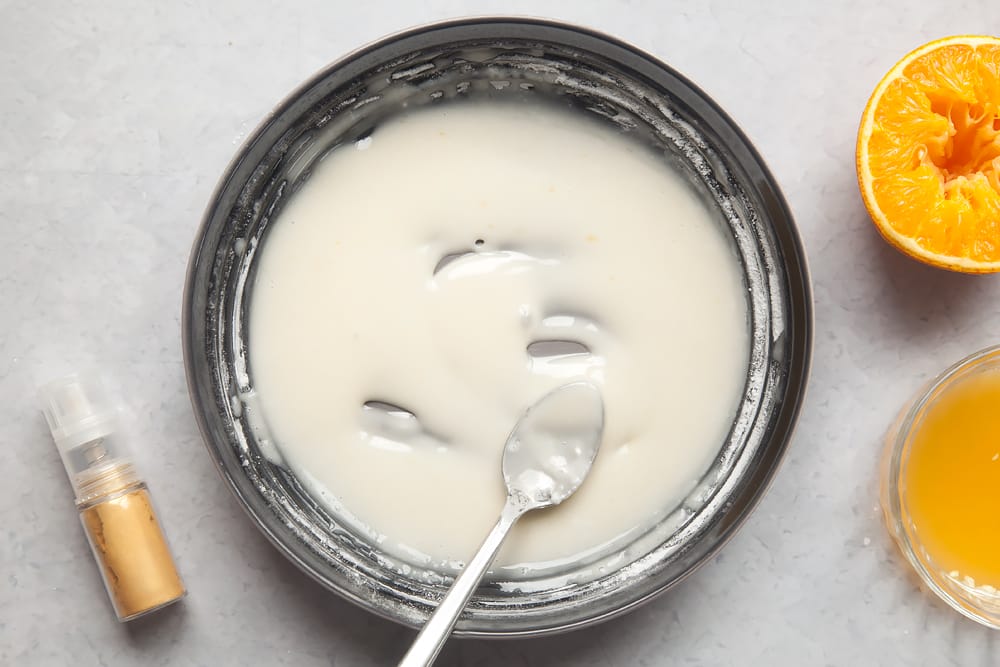 Overhead shot of sugar and margarine mix in a large clear bowl