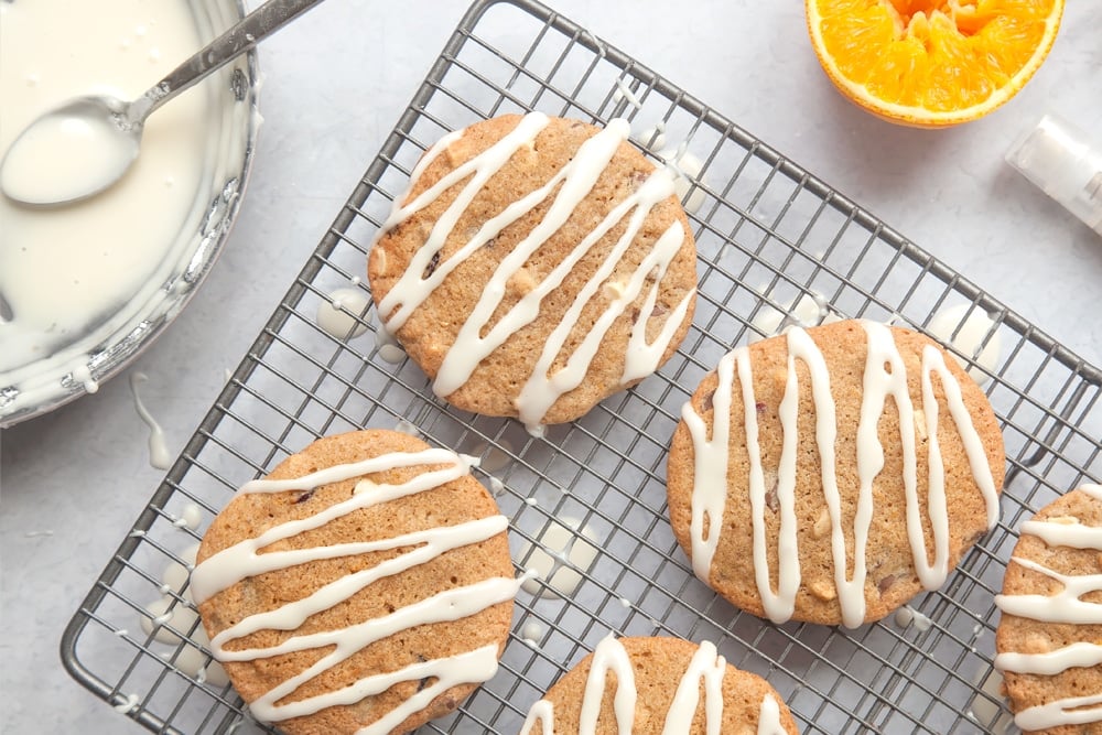 Overhead shot of Cranberry orange white chocolate cookies on a baking rack.