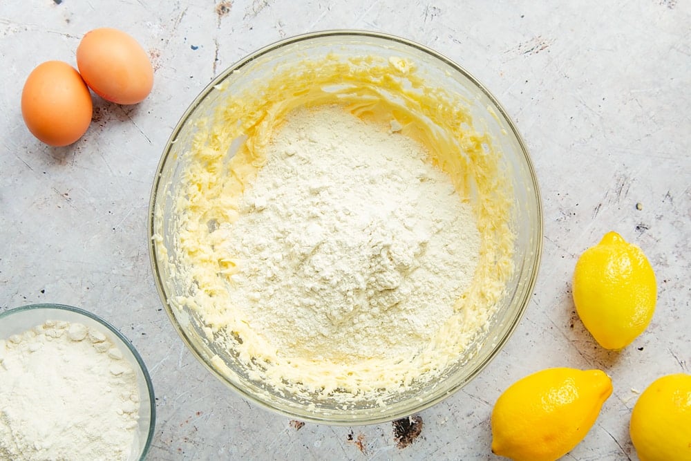 Lemon drizzle cake batter in a bowl with flour added