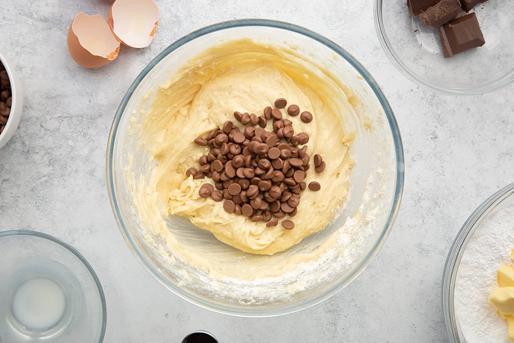Adding chocolate chips to the chocolate chip mini-loaf cake with chocolate frosting batter. 