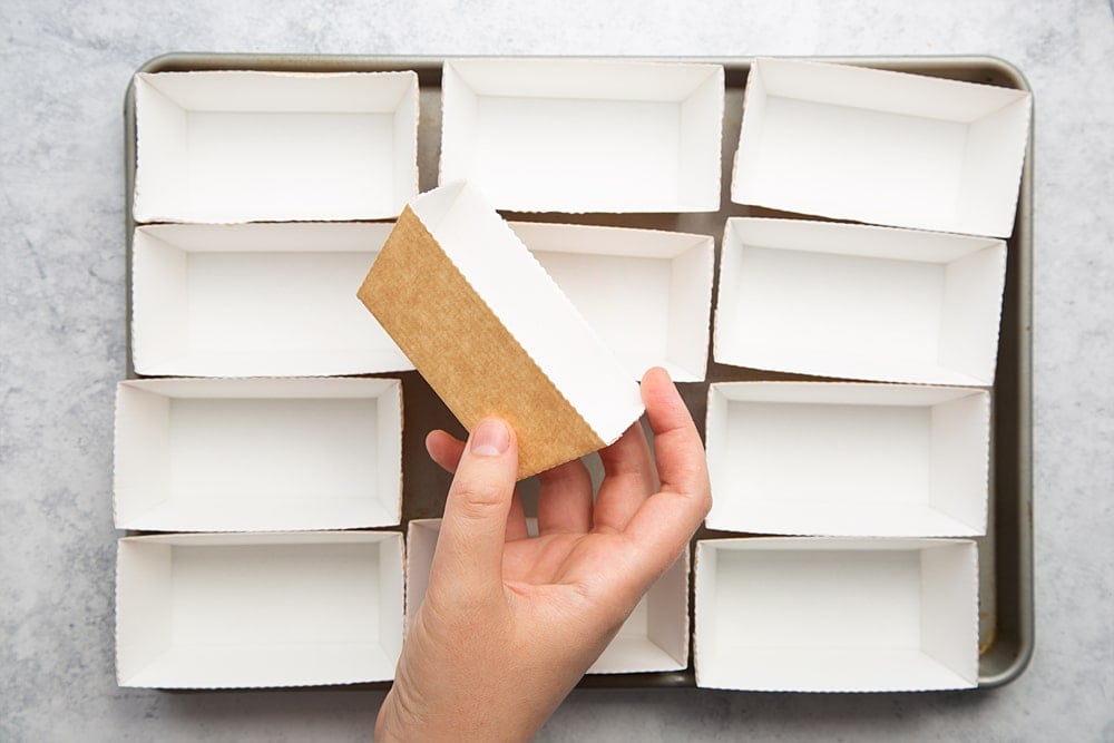 Overhead shot of twelve mini trays on a large baking tray. 