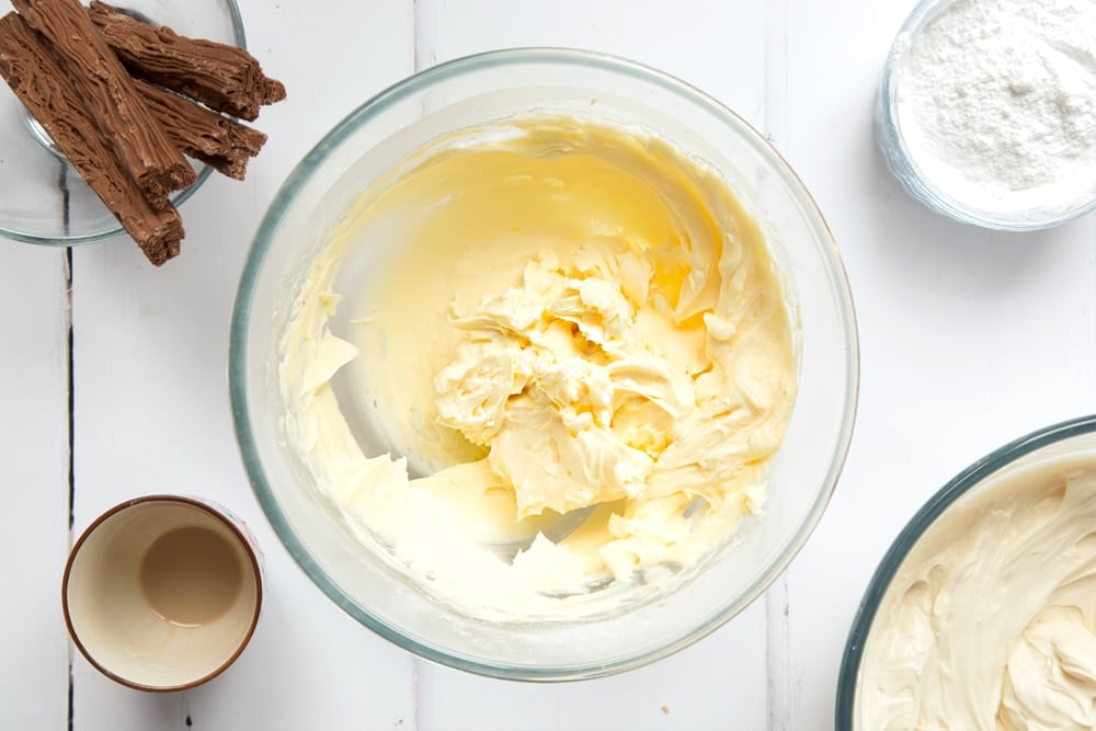 Cream and icing sugar whipped together in a mixing bowl.