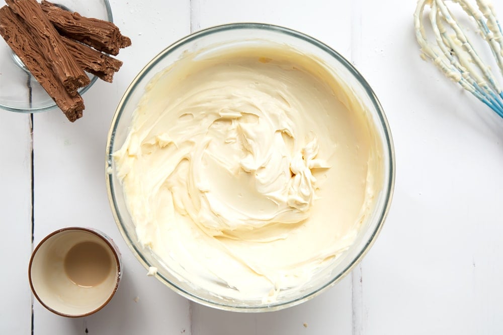 Cream, icing sugar, cream cheese and Baileys combined in a mixing bowl.