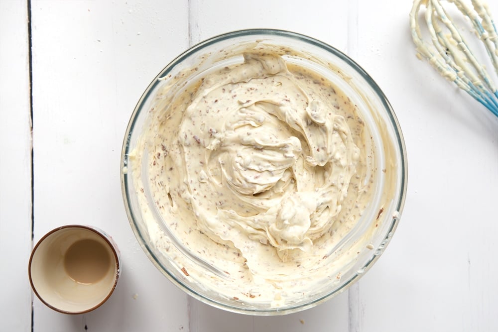 Cream, icing sugar, cream cheese, Baileys and chocolate combined in a mixing bowl.