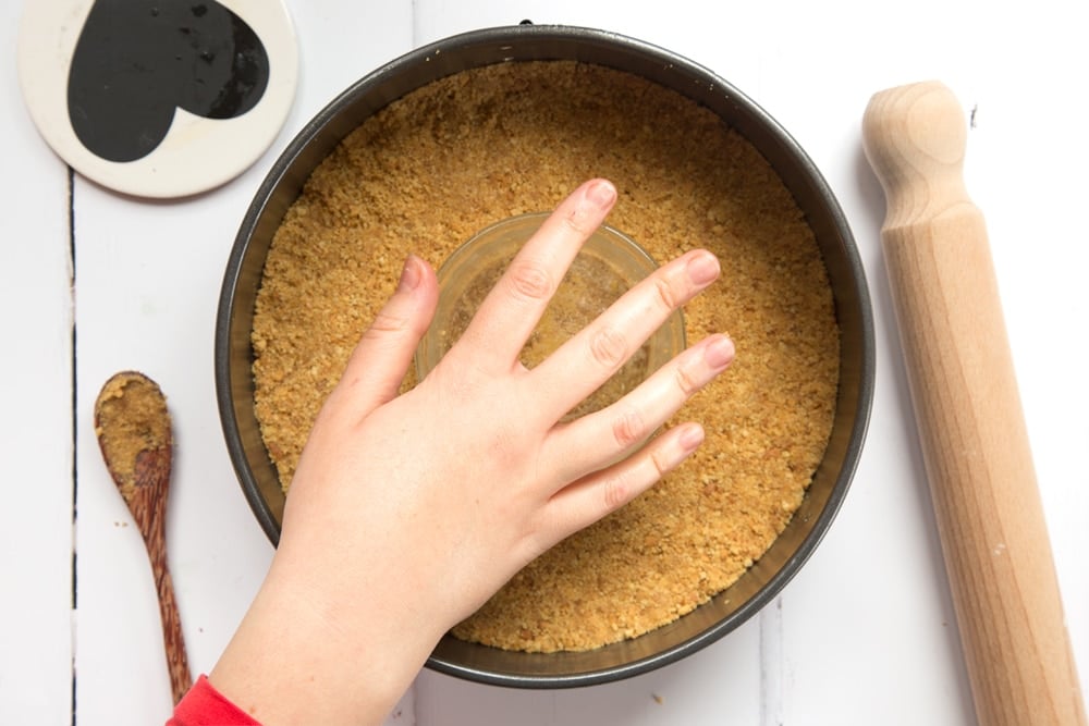 Crumbled biscuits combined with melted butter, presed into a baking tin.