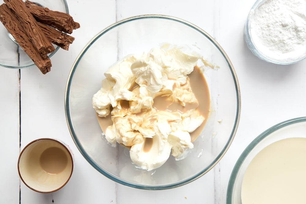 Cream cheese and Baileys in a mixing bowl.