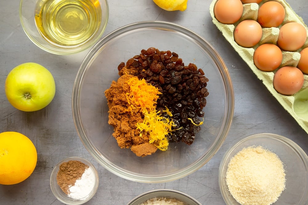 Sugar, cherries, sultanas, raisins, orange zest and lemon zest in a bowl