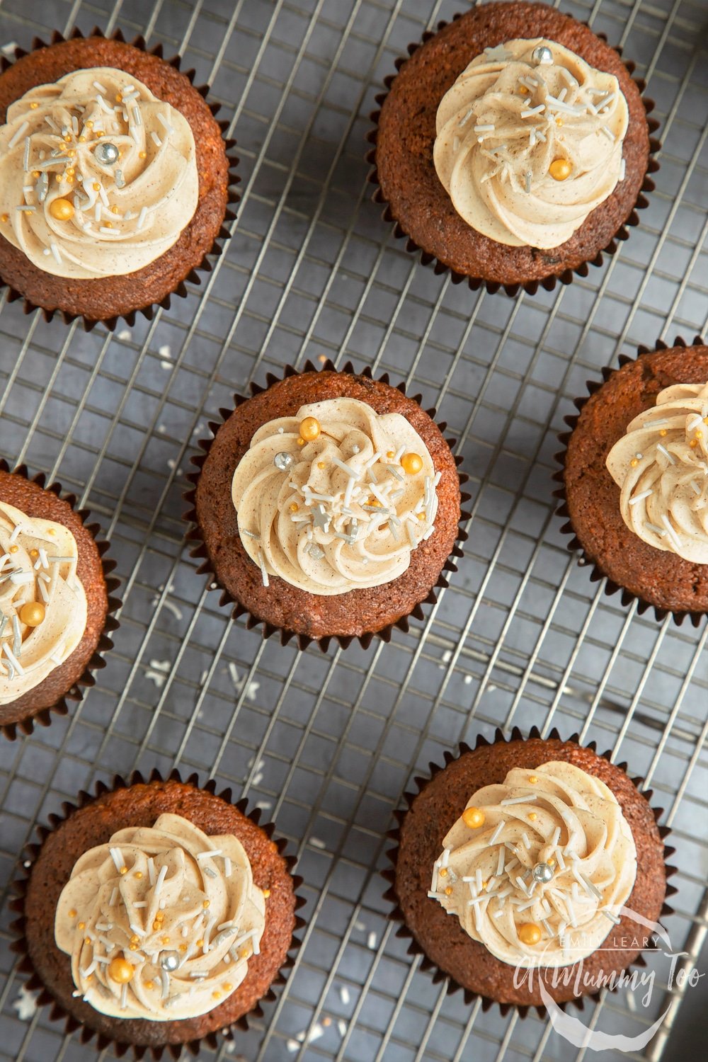 Christmas pudding muffins topped with frosting and sprinkles