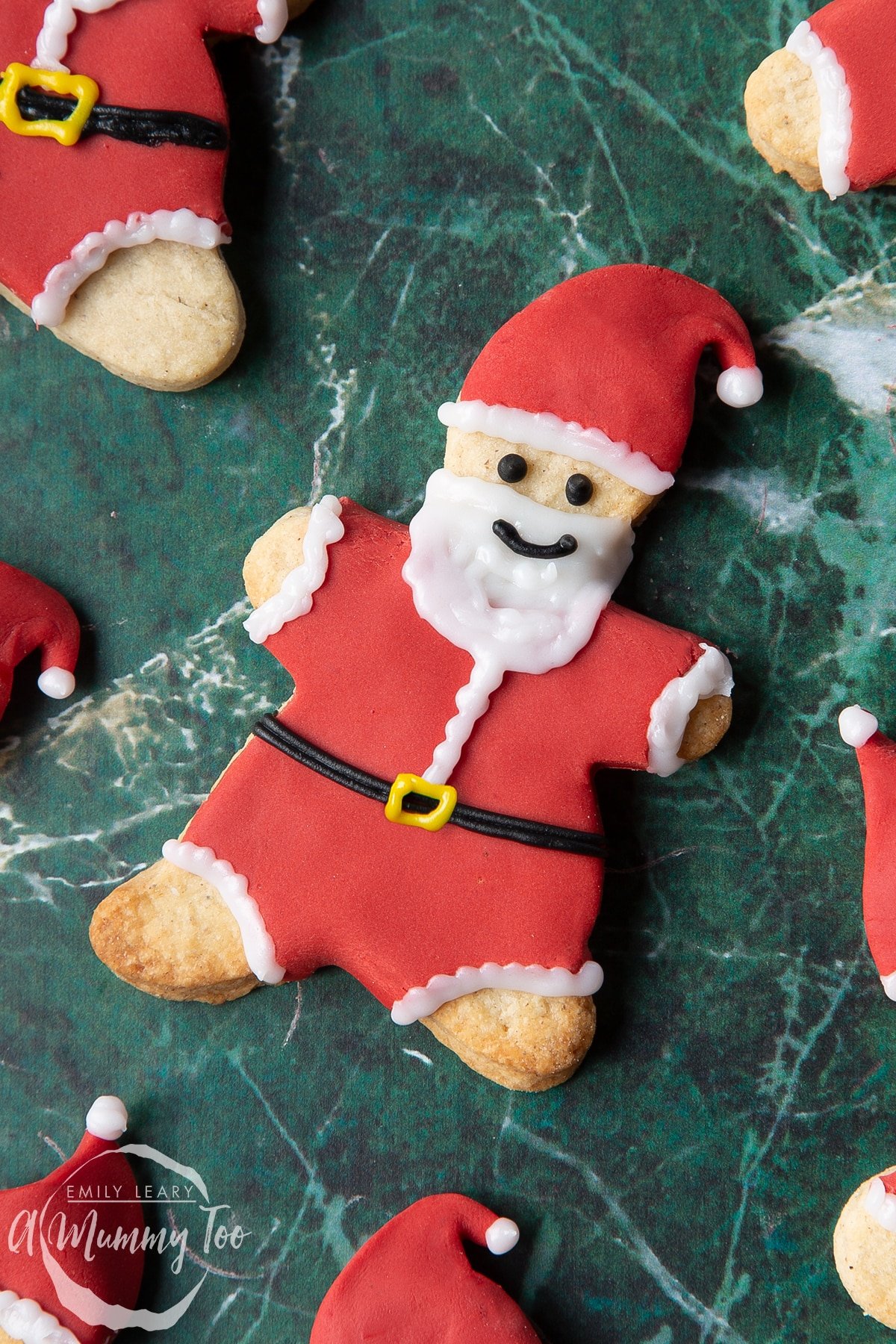 Close up of aFather Christmas cookies on a green marble surface. 