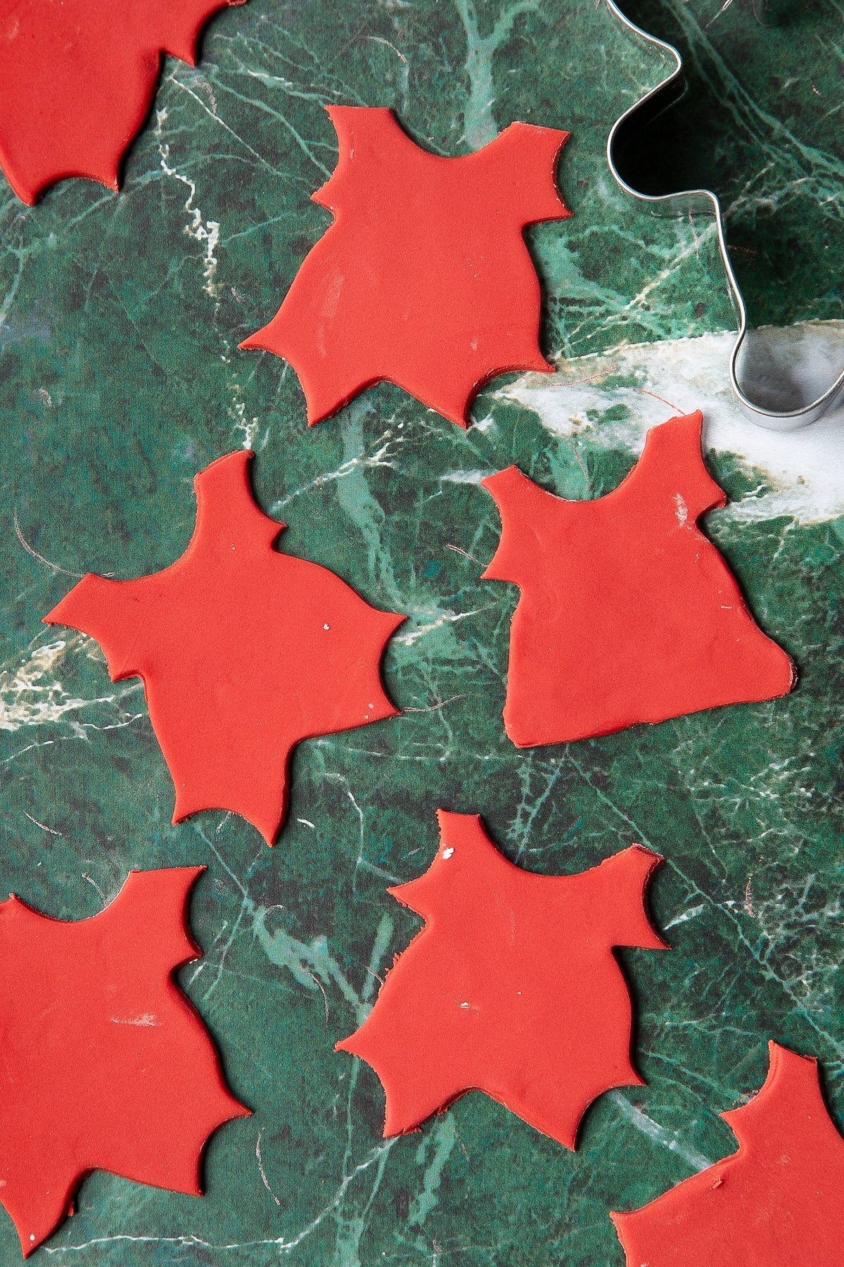 Red sugar paste cut into santa suit shapes.