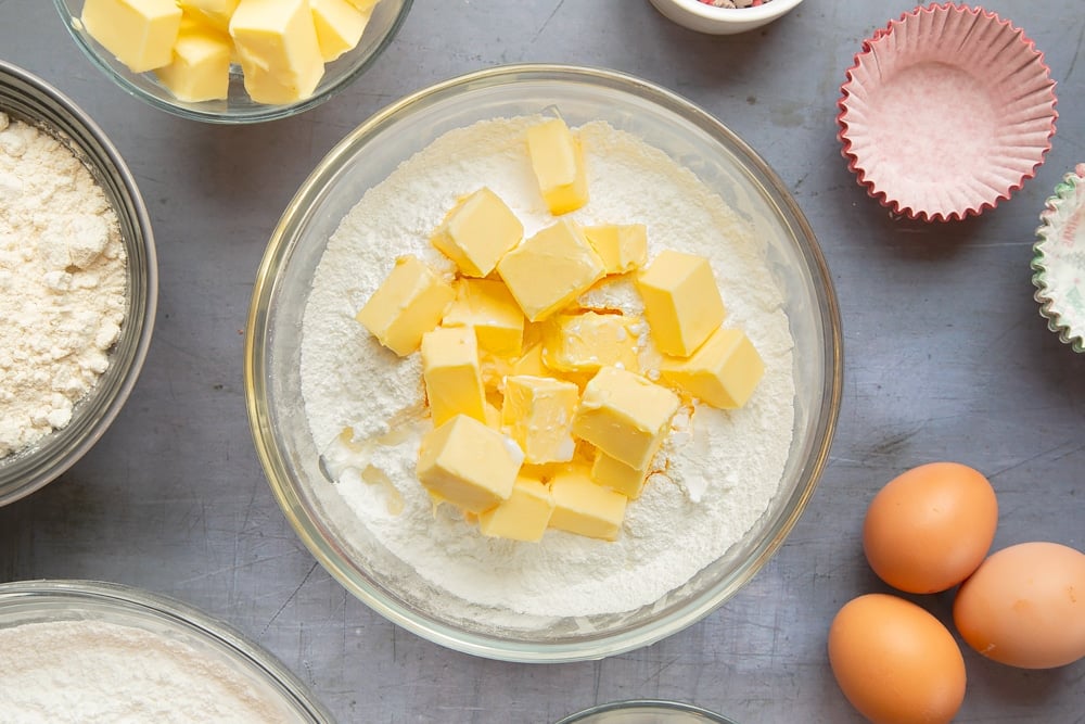 Overhead shot of a bowl with some of the ingredients inside required to make the marzipan frosting.