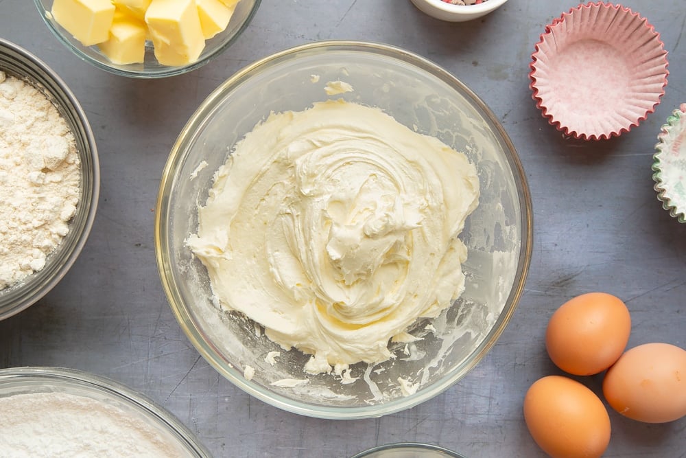 Overhead shot of the marzipan frosting mixed together in a pyrex bowl. 