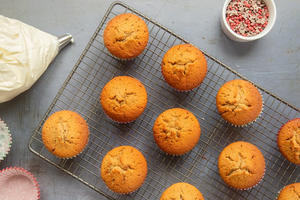 Overhead shot of the spiced Christmas cupcakes cooling on a wire rack. 