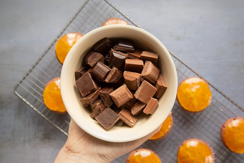 Squares of chocolate in a bowl, ready to melt