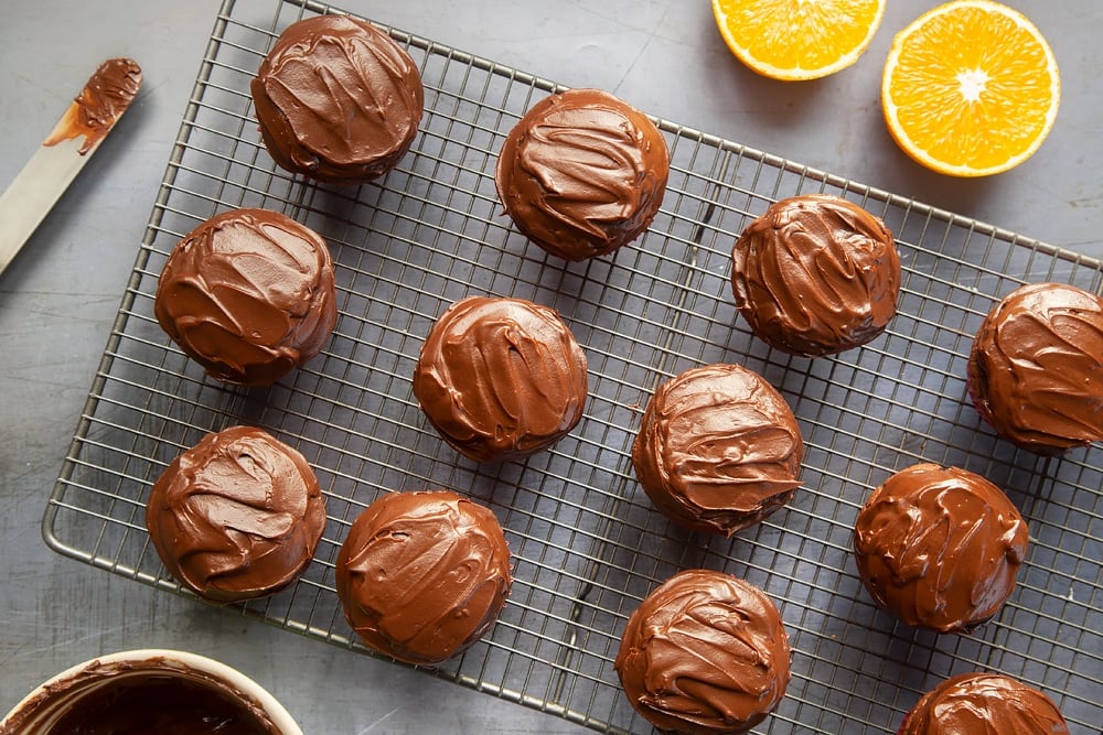 Top the Jaffa cake cupcakes with ganache