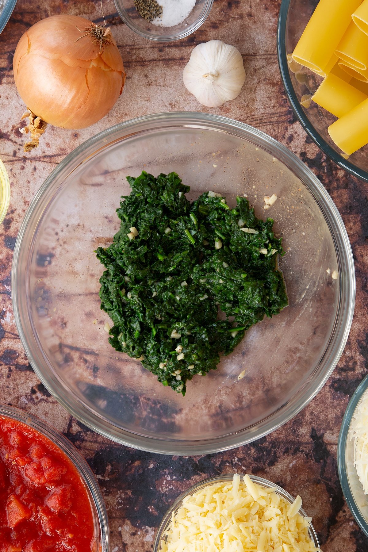 Overhead shot of finely cut cooked spinach in a bowl.