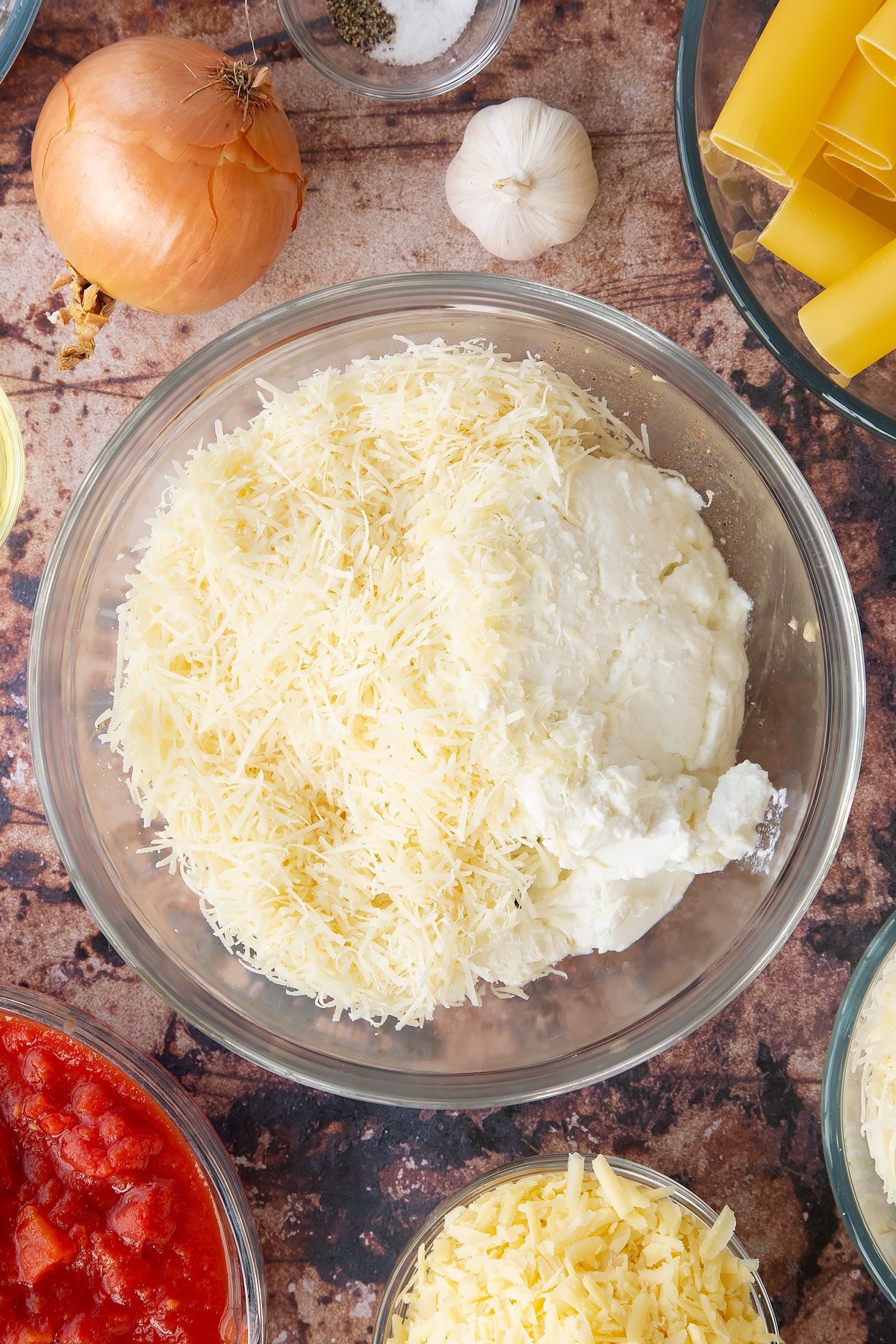 Overhead shot of some of the ingredients required to make the Spinach and ricotta cannelloni in a bowl.