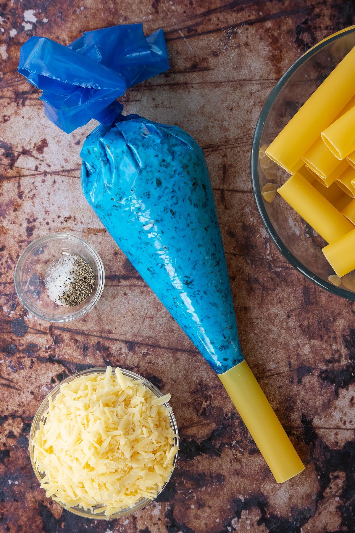 Overhead shot of a piping bag filled with the spinach and ricotta filling. 