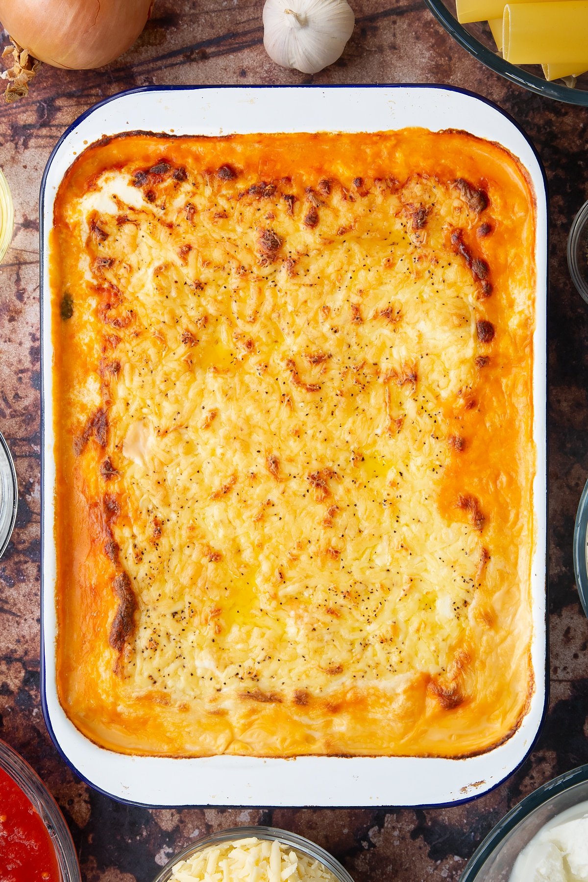 Overhead shot of the finished spinach and ricotta cannelloni after being in the oven.