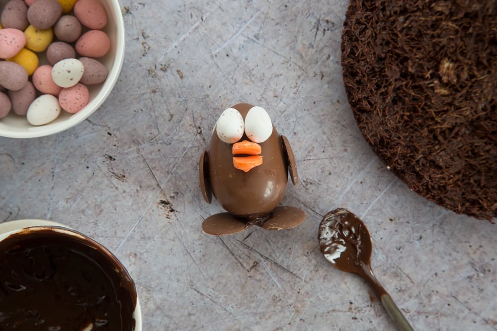 Orange buttons are added to form the chick's beak