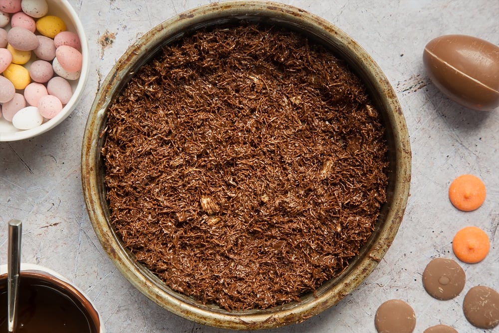 Chocolate shredded wheat in a sandwich tin, ready to be cooled in the fridge