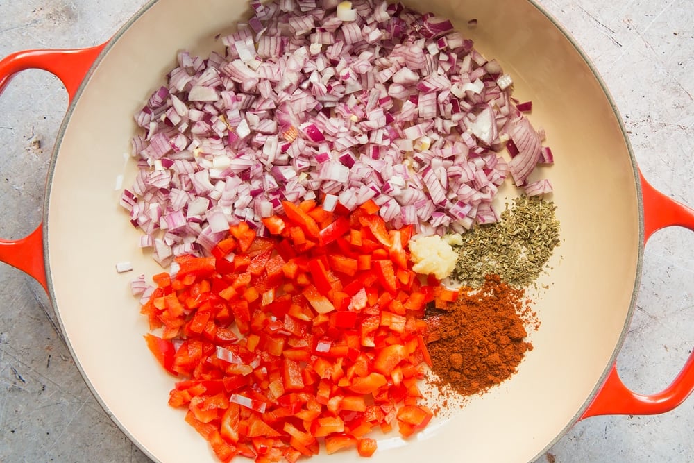 chopped onion, red pepper, garlic, oregano and chilli powder in a large skillet pan