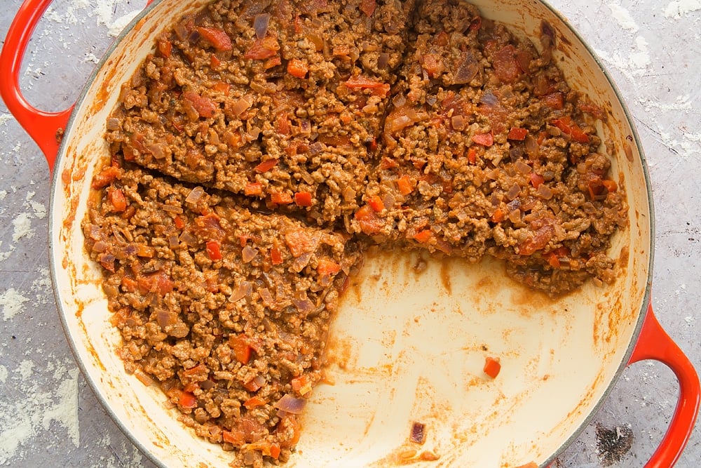 Cooked onion, red pepper, garlic, oregano and chilli powder, beef mince with chopped tomato sauce cut into quarters.