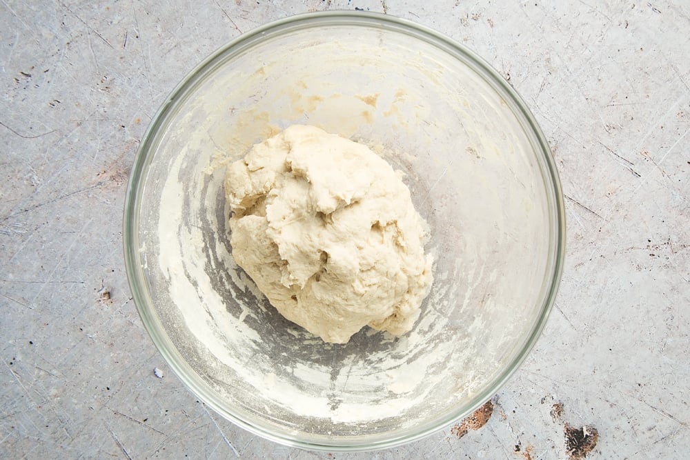 white flour dough ball in a clear bowl