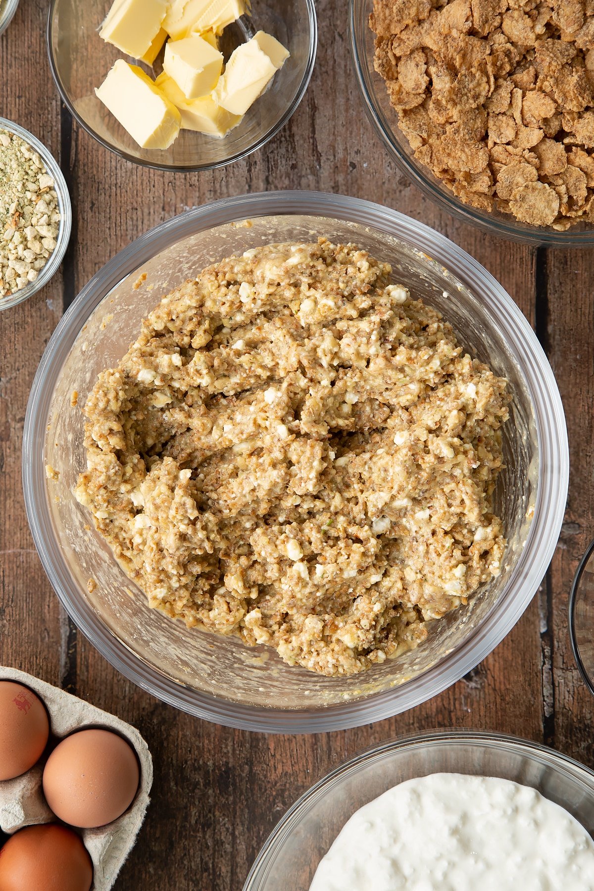 Overhead shot of some of the ingredients required to make the special k loaf together in a clear bowl.