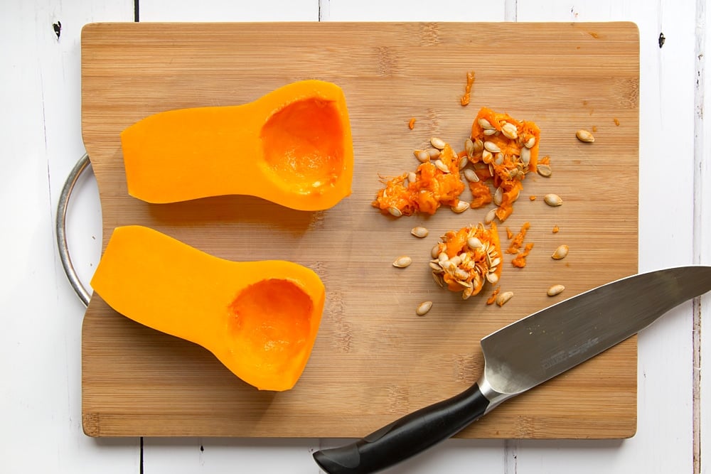To start the roasted butternut squash soup you'll need to cut the butternut squash. 