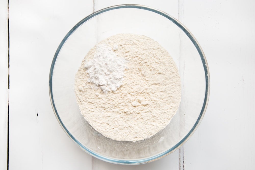 Flour, arrowroot and baking powder in a bowl to create vegan american pancakes