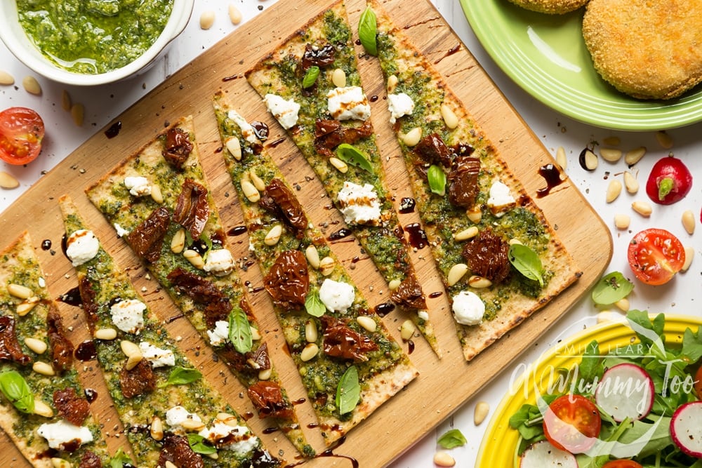 Pesto flatbread pizzas, sliced and served with a side salad