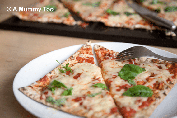 Flatbread pizzas topped with cheese and basil