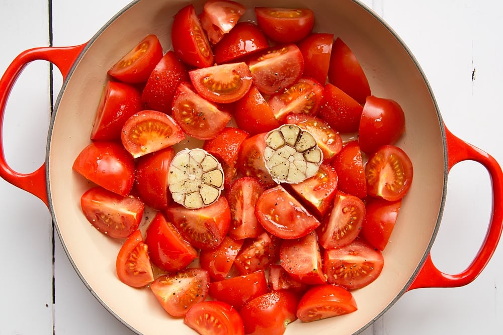 Sliced tomatoes and garlic in a pan