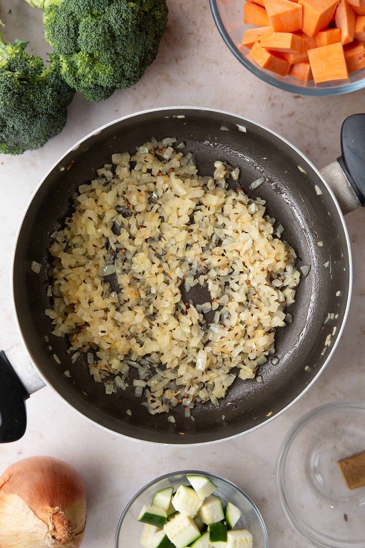 Overhead shot of the diced onions inside a pan having been fried for a couple of minutes.