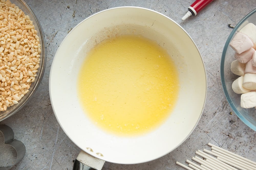 Melting butter in a pan for the heart shaped crispy cake pops.