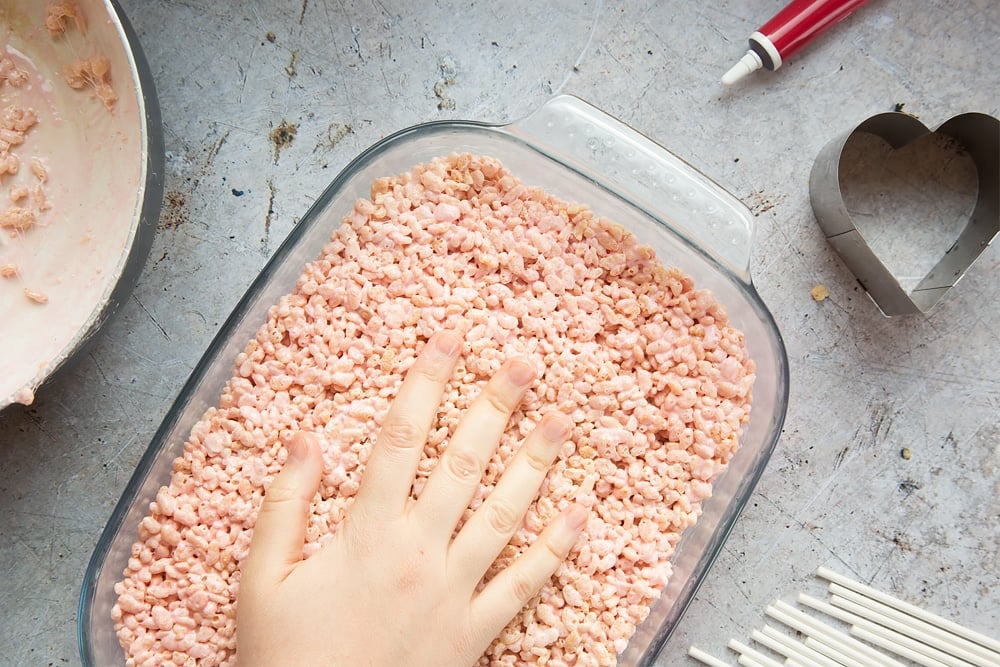 Pack the rice crispy mixture down into the tray